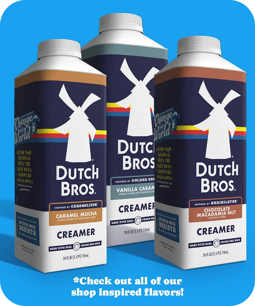 Three Dutch Bros coffee creamers in different flavors: Caramel Mocha, Vanilla Caramel, and Chocolate Macadamia Nut on blue background.