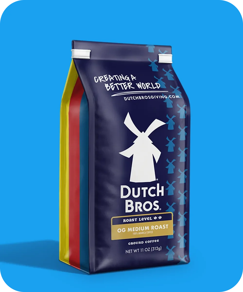 Navy blue Dutch Bros coffee bag featuring white windmill logo and OG Medium Roast label against bright blue background.