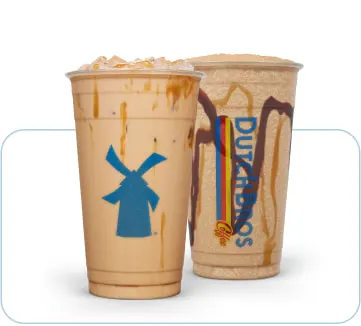 Two iced coffee drinks in plastic cups - one with a blue windmill logo, the other with a Dutch Bros logo.
