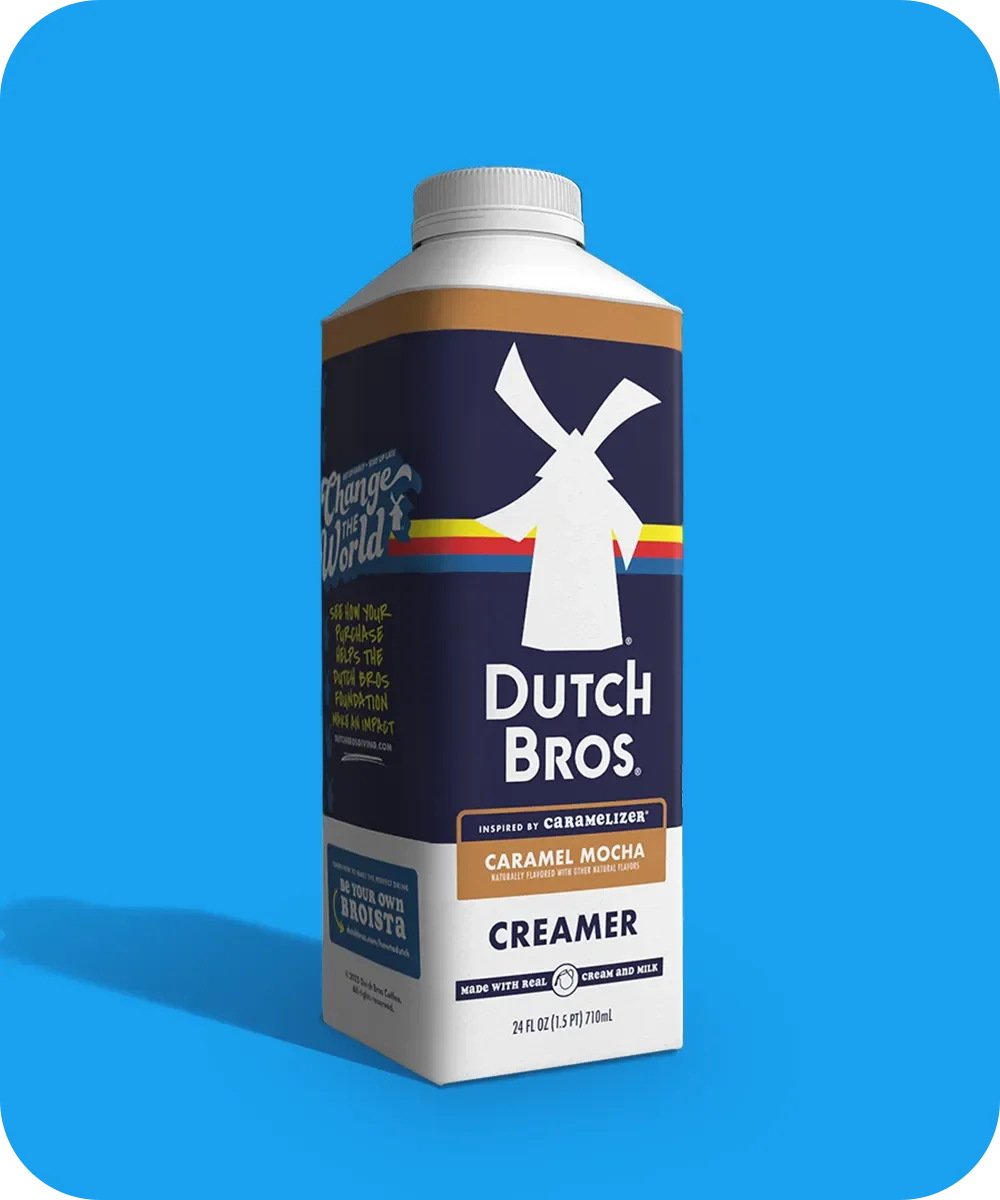 Dutch Bros coffee creamer bottle in Caramel Mocha flavor with windmill logo on blue background.