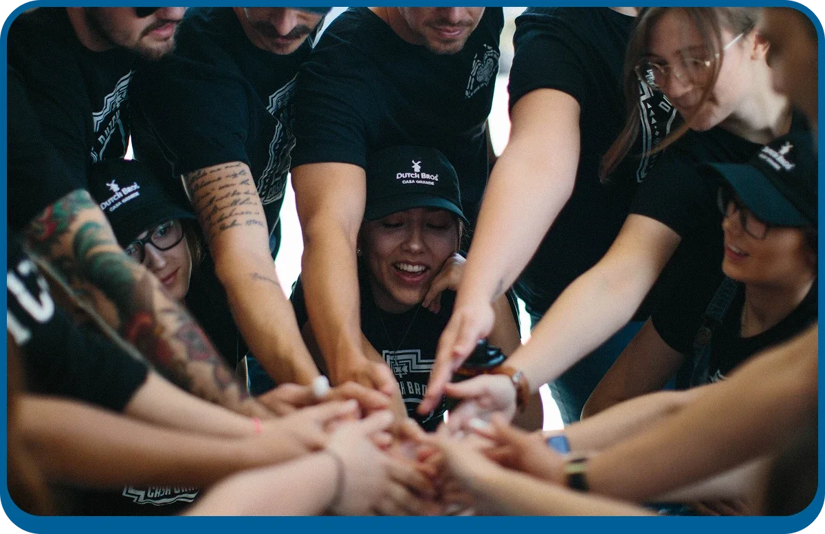 broistas putting their hands in a circle together