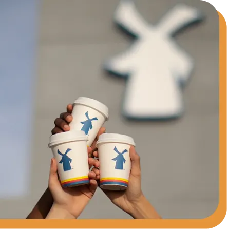 3 coffees cheersing in front of dutch bros