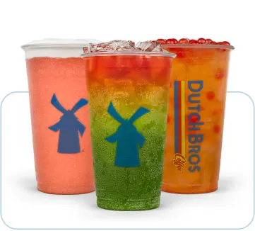 Three colorful Dutch Bros drinks in clear cups - pink, rainbow layered, and orange beverages with windmill logos.