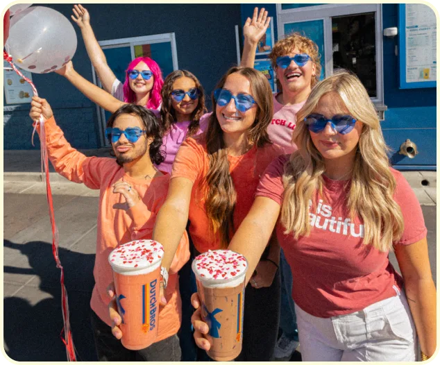 group of broistas in front of dutch bros with drinks