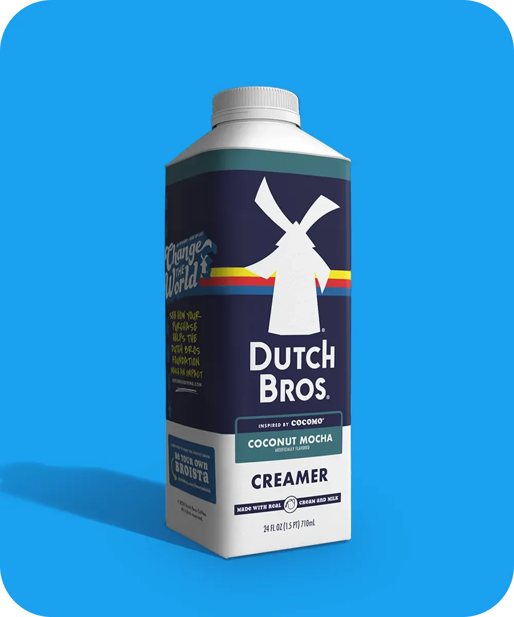Dutch Bros Coconut Mocha coffee creamer carton with windmill logo against bright blue background.